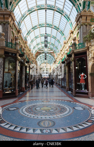 Floor mosaic and traditional upmarket designer shops in County Arcade in Victoria Quarter shopping centre in Leeds Yorkshire England UK Stock Photo