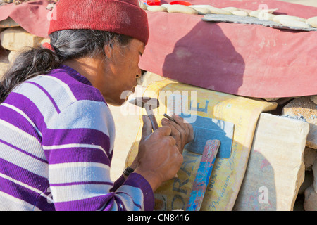 Tibetan carving mantras on stones under Swayambhunath Stupa, Kathmandu, Nepal Stock Photo