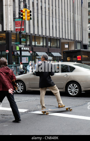United States, New York City, Manhattan, Midtown, businessman on a skateboard Stock Photo