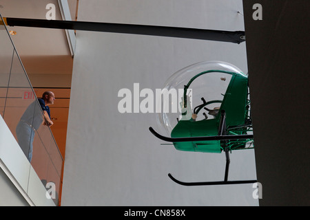 United States, New York City, Manhattan, Midtown, Museum of Modern Art (MOMA), visitor in front of Bell 47D1 helicopter Stock Photo