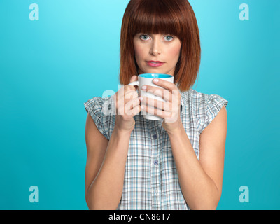 https://l450v.alamy.com/450v/cn86t7/beautiful-young-woman-drinking-a-big-cup-of-coffee-on-blue-background-cn86t7.jpg