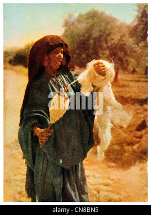 First published 1914  woman spinning cotton thread Jericho Jerusalem Stock Photo