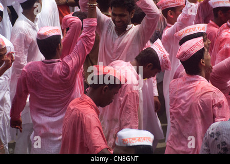 Devotees smeared in Pink Color during the Ganesh Visarjan procession - Lalbaug, Mumbai, India Stock Photo