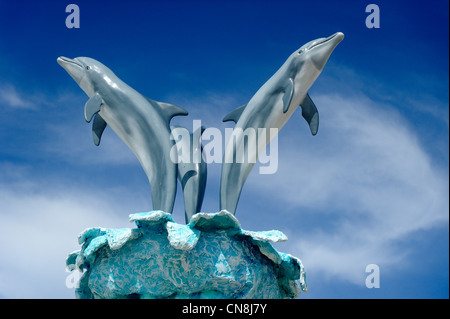 Bahamas, Grand Bahama Island, Freeport, Port Lucaya, sculptures resin dolphins on blue sky background Stock Photo