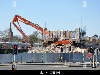 Excavator with long reach attachment working on demolition site, Wigston, Leicestershire, England, UK Stock Photo