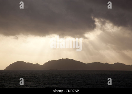 Sun rays coming through the clouds over the ocean sailing out of Vigo, Spain. Stock Photo