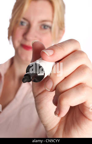 Close up of a smiling lady holding a marker pen towards camera Stock Photo
