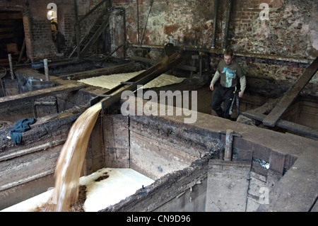 Mixing the liquor for traditional oak bark tanning at Bakers Tannery Colyton Devon England Stock Photo