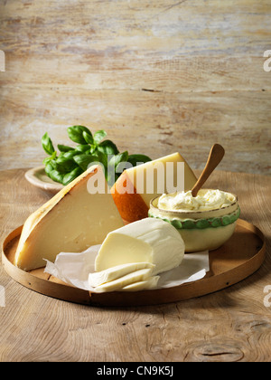 Italian cheeses on wooden board Stock Photo