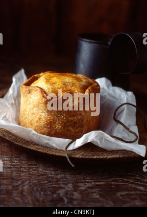 Close up of pork pie on wooden board Stock Photo