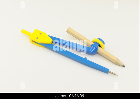 compass with pencil blue yellow plastic taken on a white background Stock Photo