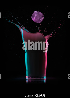 An ice cube splashing into a refreshing drink Stock Photo - Alamy