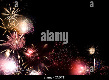 Beautiful fireworks going off with plenty of room for your text in the dark night sky. Stock Photo