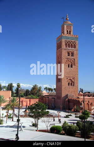 The minaret of the Koutoubia mosque on Ave. Mohammed 5; against snow capped High Atlas mountains, Marrakech,Morocco, Africa- Stock Photo