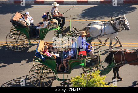 Tourists take horse drawn carriage rides in caleches along Avenue Mohammed V, Marrakech, Morocco, north Africa Stock Photo