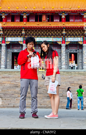 Young male and female visitors on the steps of Wenwu Temple, Sun Moon Lake, Taiwan. JMH5844 Stock Photo