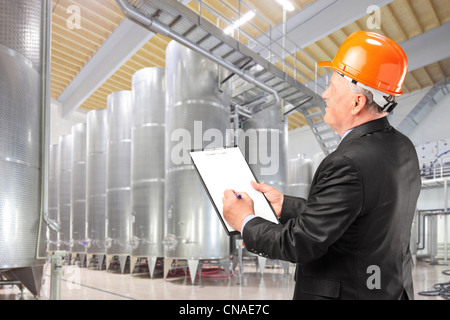 A construction worker with orange helmet at work place Stock Photo