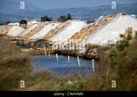 Piles of salt stored in the Salt Pans in Trapani, Sicily, Italy Stock Photo