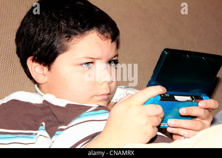 a kid or child using an electronic device or game or nintendo or video game Stock Photo