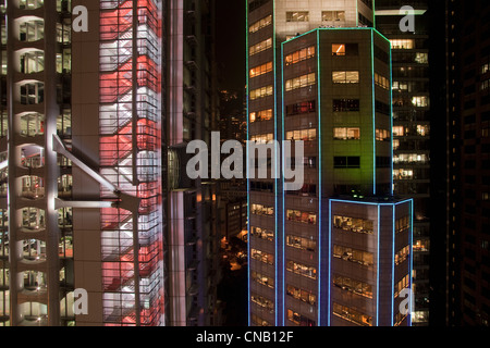 Urban skyscrapers lit up at night Stock Photo