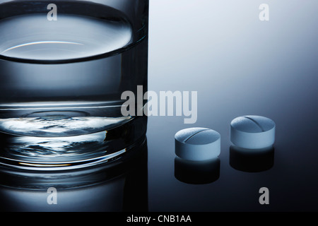 Close up of pills on reflective surface Stock Photo