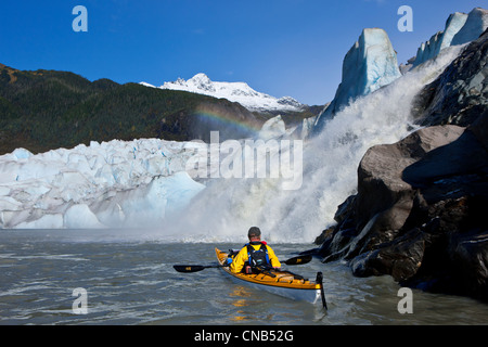 Sea kayaker on Mendenhall Lake with Mendenhall Glacier and Nugget Falls in the background, Southeast Alaska, Summer Stock Photo
