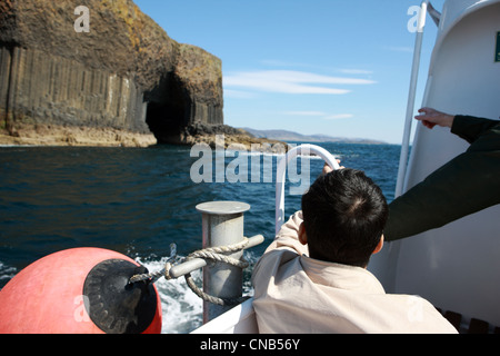 Tourists approaching Fingal's cave on Staffa in Scotland