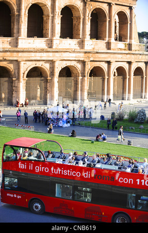 Sightseeing Bus Passing The Colosseum in Rome. Stock Photo