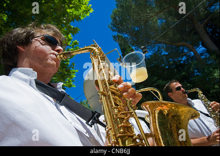 France, Gard, Aigues Vives, musician of a local pena with his glass of pastis during a local festival Stock Photo