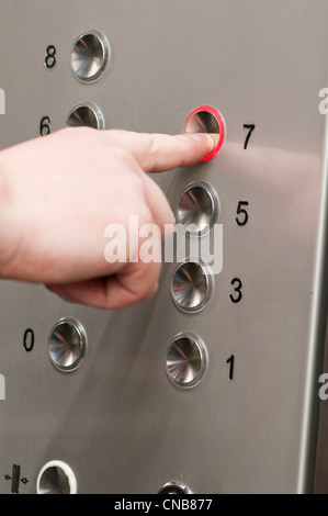 white man pushing buttons on an elevator Stock Photo