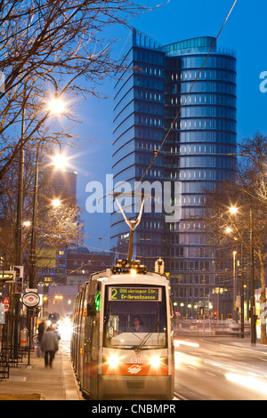 Austria, Vienna, tramway with UNIQA Tower in the background, designed by Austrian larchitect Heinz Neumann, located along the Stock Photo