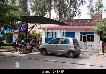 Cars and bikes in a small parking located at the Monty Millions restaurant on the way to Lansdowne in Uttarakhand in India Stock Photo