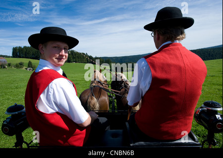 Father and son on a horse-drawn cart on the traditional Rosstag day, St. Maergen, Germany Stock Photo
