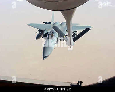 An F-15 Eagle moves in to be refueled by a KC-135R Stratotanker from the 319th Air Refueling Wing of Grand Forks Air Force Base, N.D., on April 12 , 2012 over the Central United States. Stock Photo