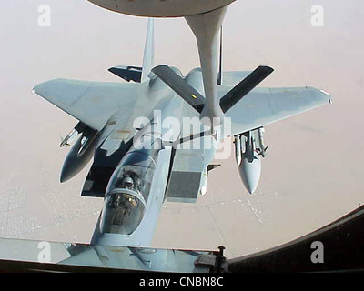 An F-15 Eagle moves in to be refueled by a KC-135R Stratotanker from the 319th Air Refueling Wing of Grand Forks Air Force Base, N.D., on April 12 , 2012 over the Central United States. Stock Photo