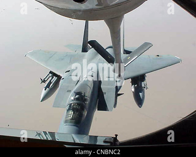 An F-15 Eagle moves in to be refueled by a KC-135R Stratotanker from the 319th Air Refueling Wing of Grand Forks Air Force Base, N.D., on April 12 , 2012 over the Central United States. Stock Photo