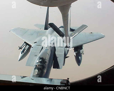 An F-15 Eagle moves in to be refueled by a KC-135R Stratotanker from the 319th Air Refueling Wing of Grand Forks Air Force Base, N.D., on April 12 , 2012 over the Central United States. Stock Photo