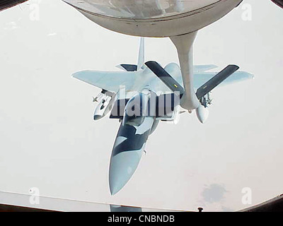 An F-15 Eagle moves in to be refueled by a KC-135R Stratotanker from the 319th Air Refueling Wing of Grand Forks Air Force Base, N.D., on April 12 , 2012 over the Central United States. Stock Photo