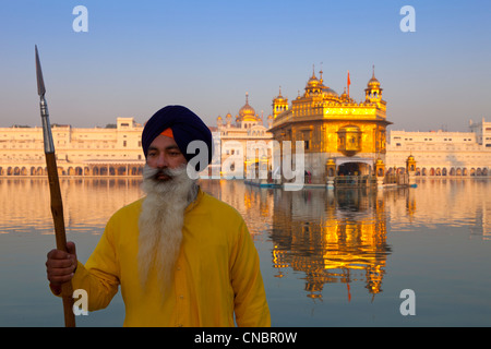 India, Punjab, Amritsar, Golden Temple and Sikh guard at sunrise Stock Photo