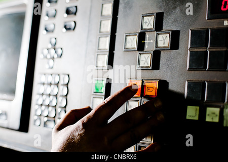 Hand on the button near screen Stock Photo