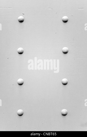 White metal wall with rivets and bolts, vintage industrial background ...