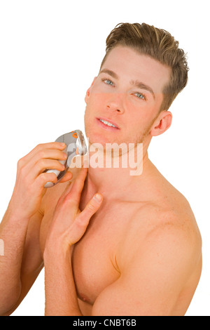 Young man shaves with electric razor Stock Photo