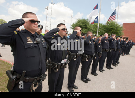 Officers salute during funeral for Austin Police Officer Jaime Padron, who was killed in the line of duty in a full ceremony Stock Photo