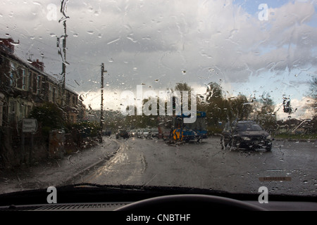 rain covered car windscreen, looking at traffic through rain covered car windscreen. Stock Photo