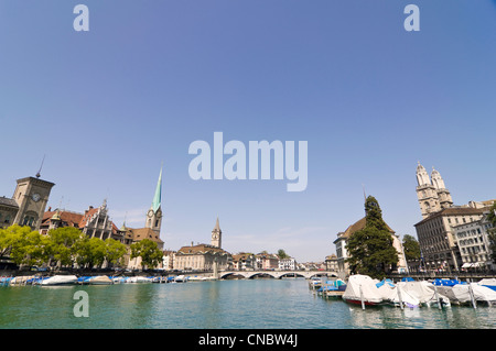 Horizontal wide angle of the stunning Zurich skyline including the spires of Fraumünster and Grossmunster on a sunny day