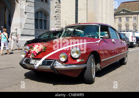 Horizontal wide angle of a pristine Citroën DS series 2 parked outside a registry office. Stock Photo