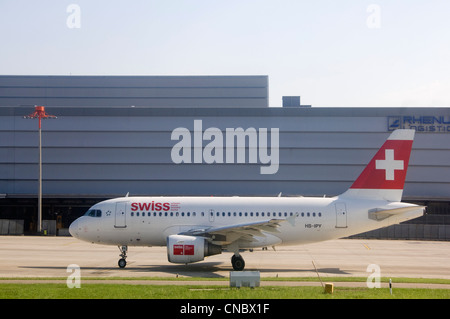 Horizontal view of a Swiss International Air lines plane waiting on the tarmac to take-off on a sunny day. Stock Photo