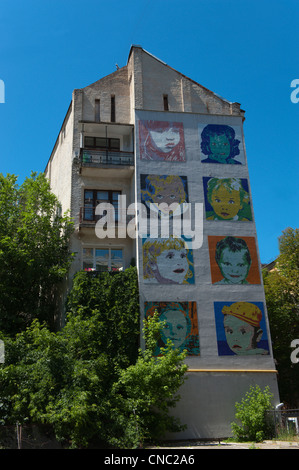 Murals of childrens faces painted on a gable wall, corner of Striletska and Strilenska streets, Kiev, Ukraine, Europe. Stock Photo