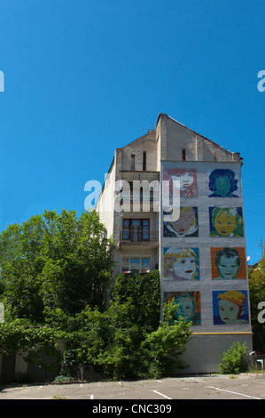 Murals of childrens faces painted on a gable wall, corner of Striletska and Strilenska streets, Kiev, Ukraine, Europe. Stock Photo