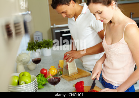 Portrait of husband and wife cooking together in the kitchen Stock Photo